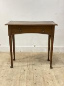 An Edwardian oak side table, fitted with one drawer raised on turned supports with pad feet,