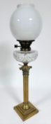 An Edwardian cast brass corinthian column oil lamp converted to electricity by Messengers A&N C.S.