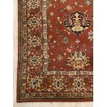 A Ziegler type carpet, the orange field with lotus head motif enclosed by border (a/f) 400cm x