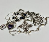 A collection of silver and white metal jewellery including a stylised cross on silver Albert, with