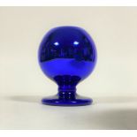 An early 20th century blue iridescent glass vase of spherical form with a pierced top and