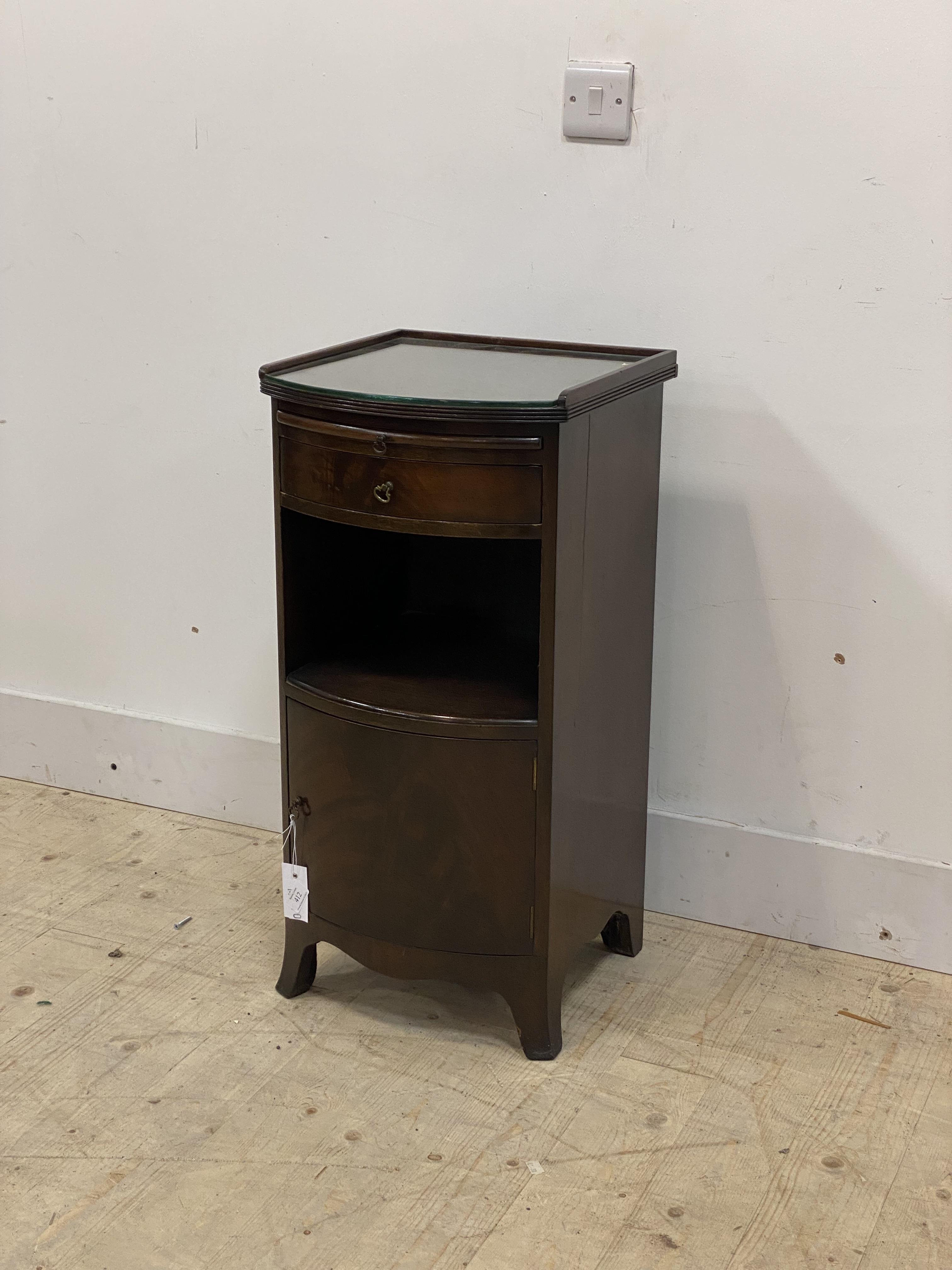 A Georgian style mahogany bow front bedside table, with plate glass top over drawer, open shelf