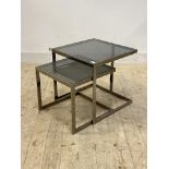 A pair of post modern chrome and smoked glass nesting tables, H50cm, 50cm x 50cm