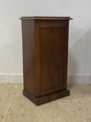 A Victorian mahogany cabinet, the panelled door enclosing pigeon holes and a drawer, raised on