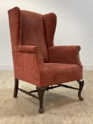 A quality Edwardian mahogany framed wing back chair in the Georgian taste, the seat upholstered in