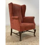 A quality Edwardian mahogany framed wing back chair in the Georgian taste, the seat upholstered in