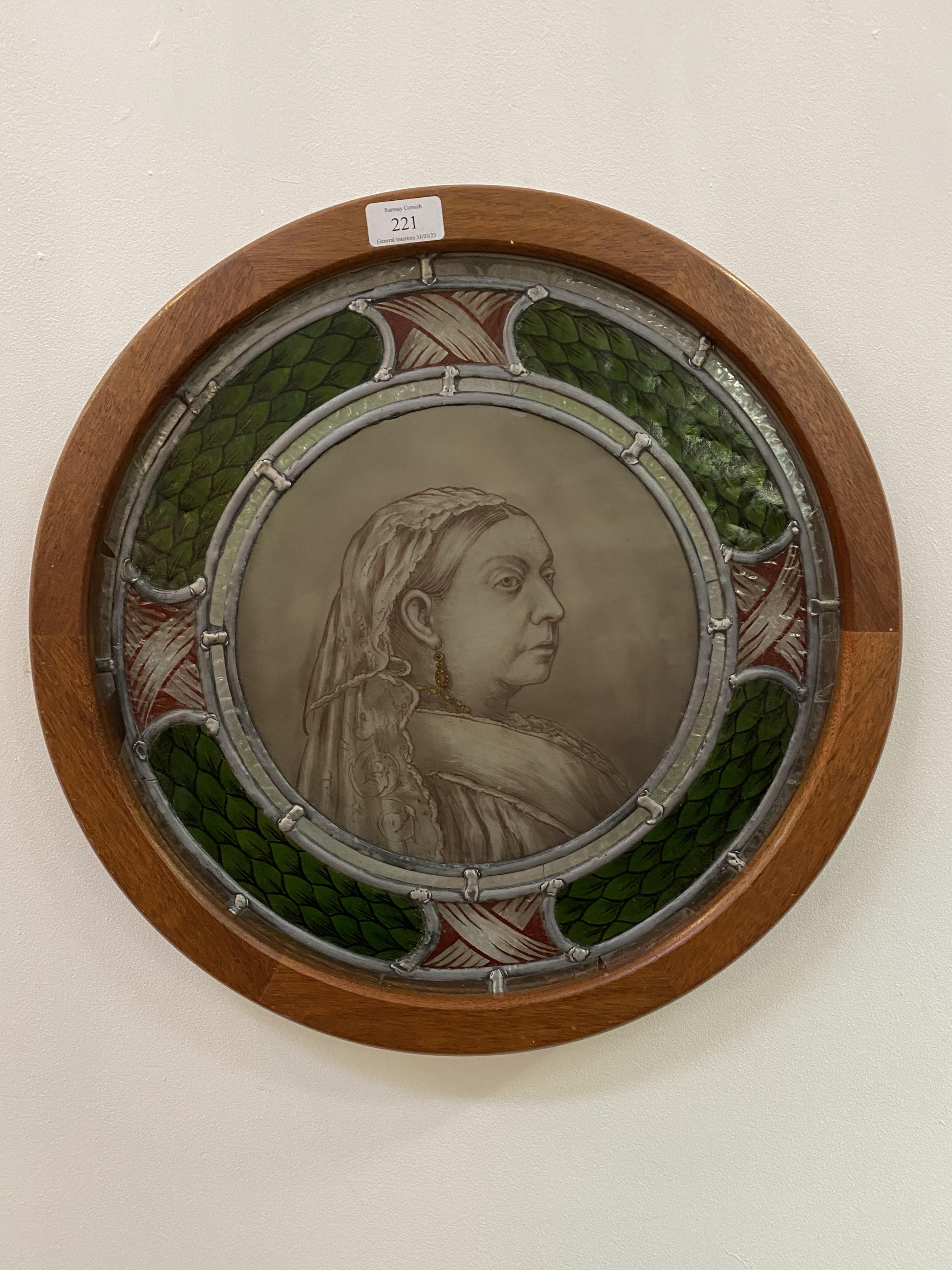 A late 19th century stained and leaded glass roundel, the central panel depicting Queen Victoria,