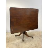 A George III mahogany tilt top breakfast table, the square top with reeded edge over ring turned