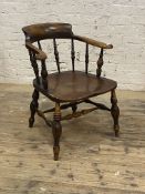 A 19th century smokers bow chair, the back and out scrolled arms on spindle gallery, deep elm saddle