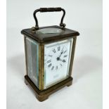 A French brass four glass carriage clock with enamelled dial, retailed by Rowell of Oxford, with