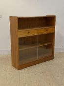 Parker Knoll, a mid century teak bookcase, with open shelf over two drawers and two sliding doors