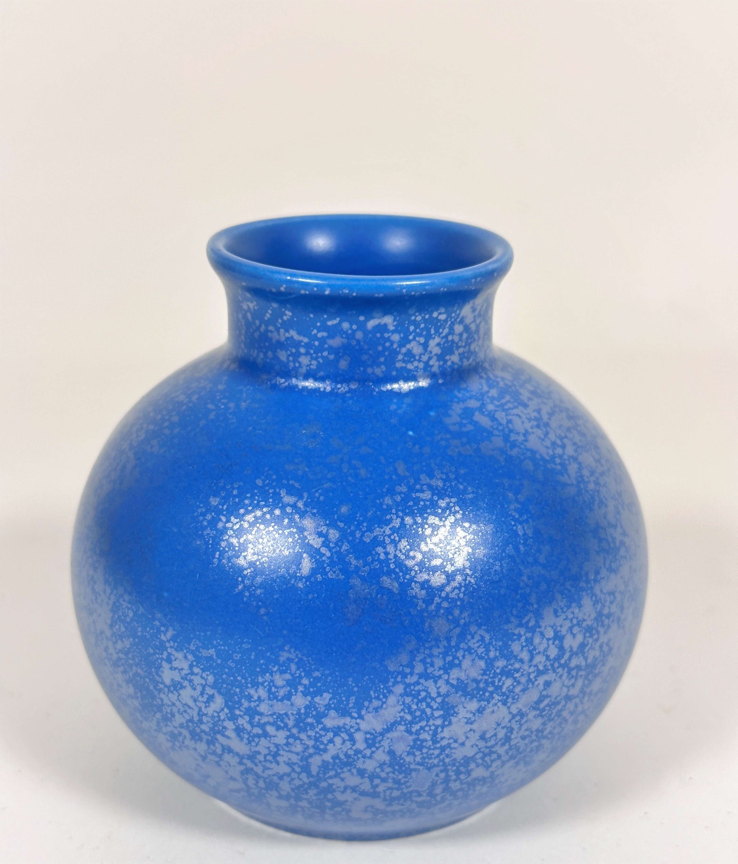 An unusual Poole pottery turquoise glazed squat vase with overlaid silver patination, signed Poole