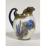 A Doulten Burslem iris pattern ceramic water jug, with scalloped rim and scrolled handle, well