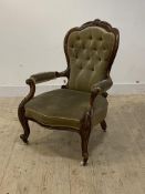 A Victorian walnut framed drawing room chair, with floral carved crest rail, buttoned back, seat and
