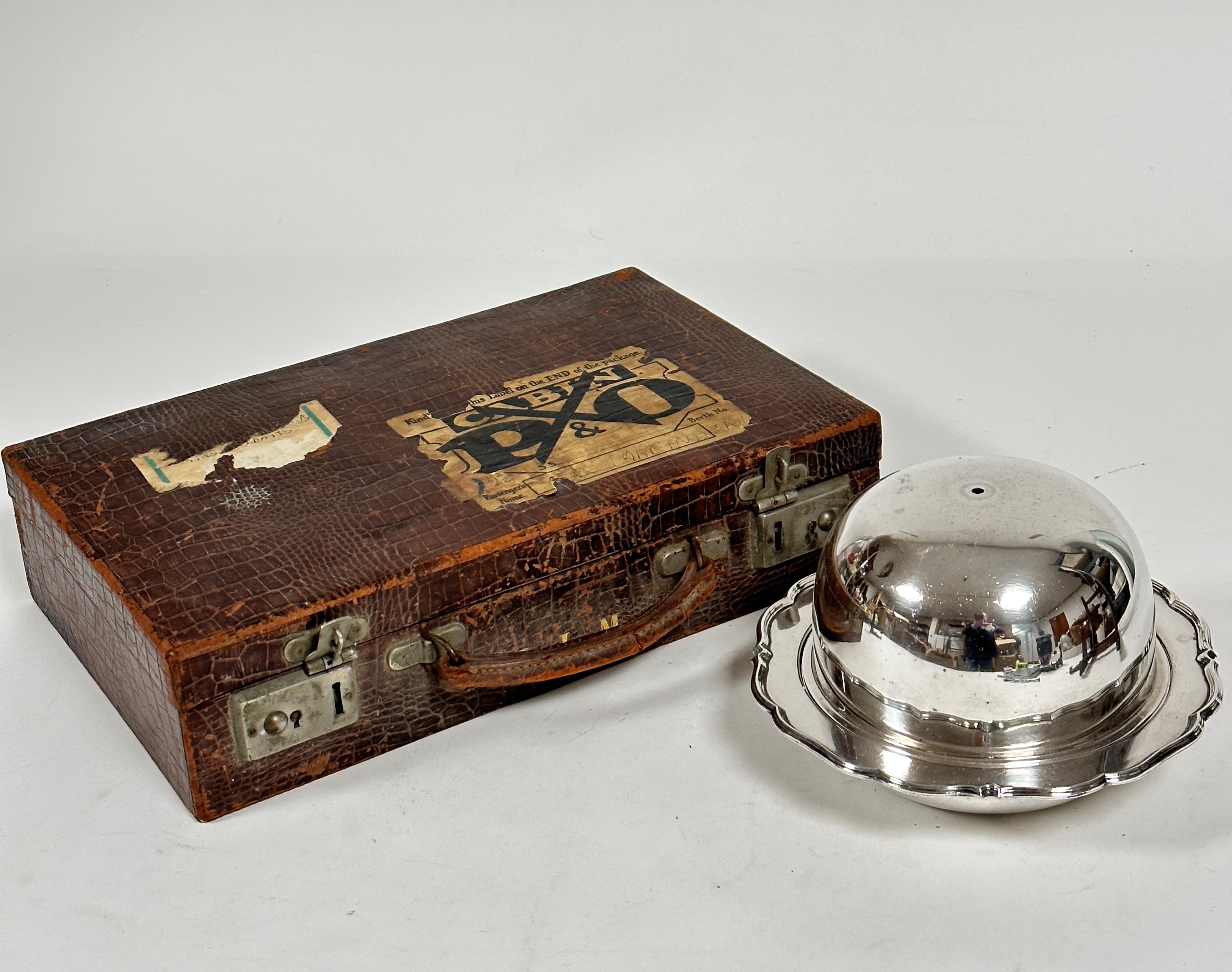 A vintage embossed leather writing case, c.1900, with part fitted interior, complete with blotter,