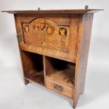 An Arts & Crafts Scottish bathroom cabinet with moulded top above an arched inlaid fruit wood