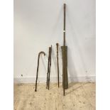 A collection of five walking sticks in a canvas bag