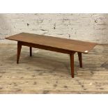 A mid century teak coffee table, the rectangular top with chamfered edge H38cm, 122cm x 40cm