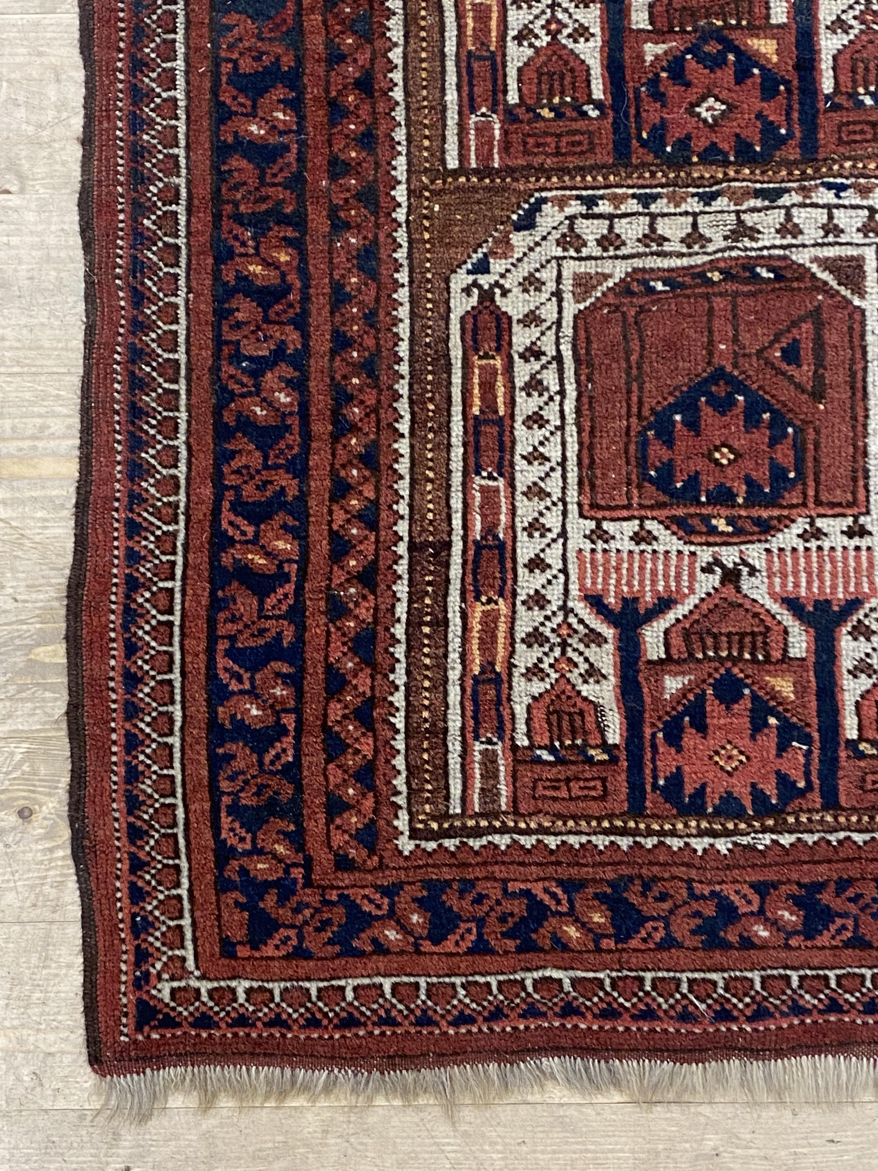 An Afghan prayer rug, the central field with mihrab within a multi line boarder 117cm x 81cm