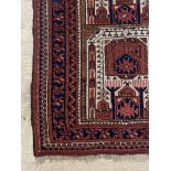 An Afghan prayer rug, the central field with mihrab within a multi line boarder 117cm x 81cm