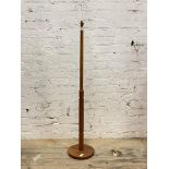 A mid century teak standard lamp, the turned and reeded stem on a circular base H141cm