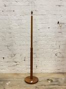A mid century teak standard lamp, the turned and reeded stem on a circular base H141cm