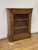 A Victorian burr walnut pier cabinet, the marquetry frieze over glazed door enclosing two shelves,