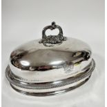 A 19thc oval meat dish cover with scroll handle to top and crest with motto FFYDDLAWN BEUNYDD,