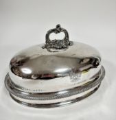 A 19thc oval meat dish cover with scroll handle to top and crest with motto FFYDDLAWN BEUNYDD,
