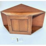 An Edwardian beech wood shaped ledgeback wall cabinet with arched top above a single panel door with