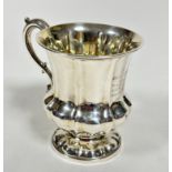 A George IV London 1836 silver baluster panelled christening mug with rococo style C scroll handle