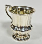 A George IV London 1836 silver baluster panelled christening mug with rococo style C scroll handle