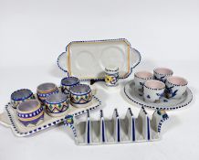 A Poole pottery 1920s / 30s stand complete with six various egg cup holders, a six division toast