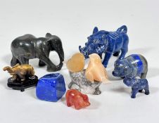 A mixed group of carved animals including a soapstone elephant figure, a block of lapis lazuli, a