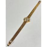 A lady's Omega 9ct gold wristwatch with silver dial and Arabic quarter hour markers and batons, (d