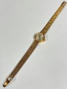 A lady's Omega 9ct gold wristwatch with silver dial and Arabic quarter hour markers and batons, (d