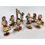 A pair of Hummel pottery figures of Boys with Toothache, two Hummel pottery figures of Girls with