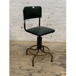 A mid century vintage machinists' chair, the green vinyl seat and back raised on a rise and fall