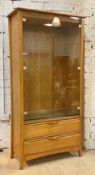Ercol, a late 20th century blonde elm display cabinet, two glazed doors enclosing three adjustable