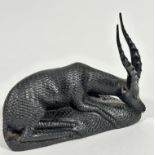 An African ebony carved seated Oryx with its head down (20.5cm x 27cm x 10cm)