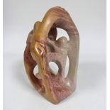 A large freeform soapstone African sculpture of variegated cream, red and orange soapstone (35cm x