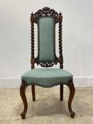 A well carved Victorian rosewood chair, the crest rail of scrolling form centred by a vacant