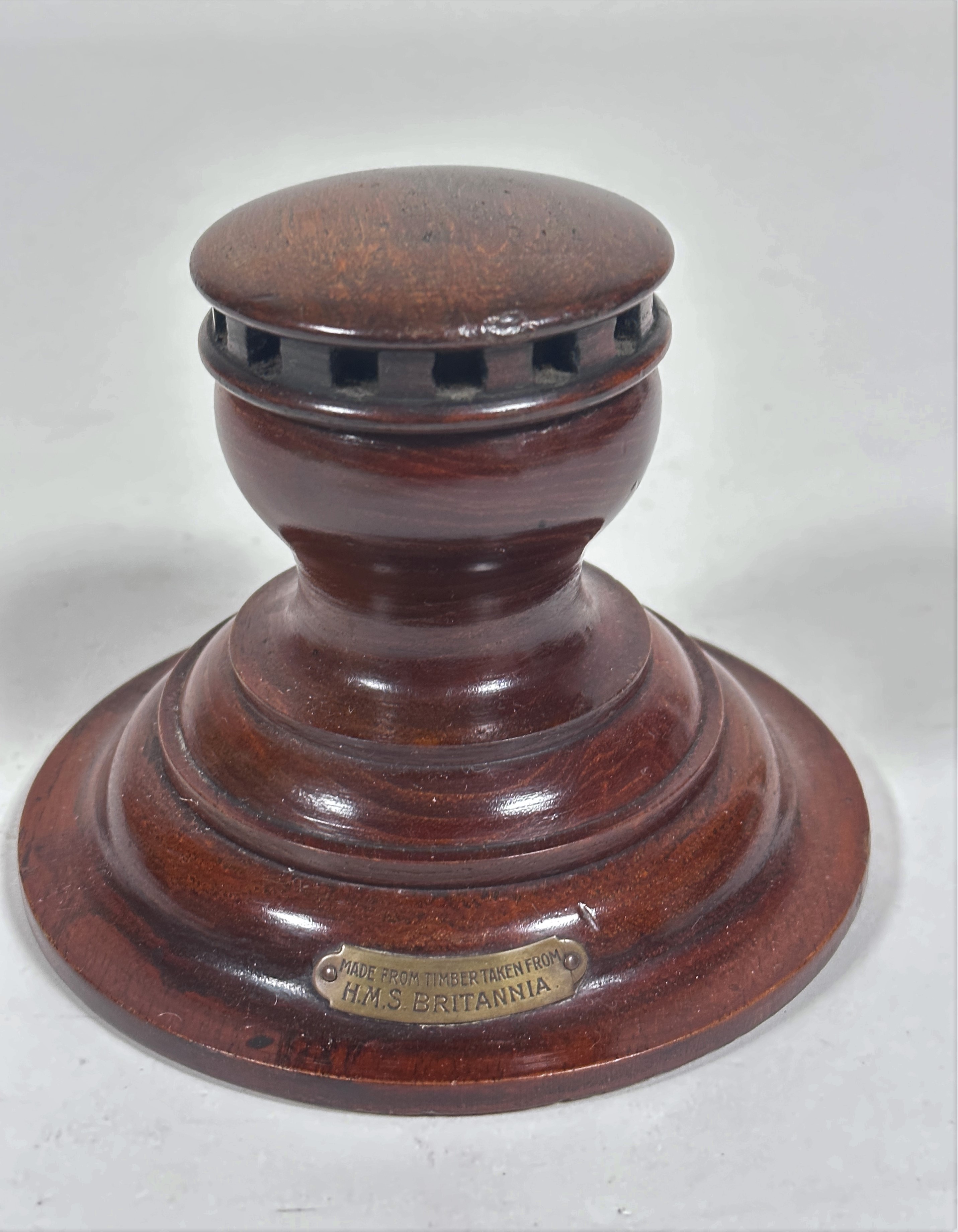 An Edwardian mahogany Capstan style inkwell, made from the timbers taken from HMS Britannia, with