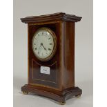 An Edwardian mantel time piece clock of concave rectangular form, the case inlaid with satinwood