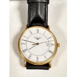 A gentleman's 18ct gold Longines wristwatch with gold bezel and enamelled dial, Roman numerals and