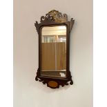 An Edwardian mahogany fretwork mirror, with ho-ho bird surmount over rectangular mirror plate within