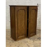 A Victorian mahogany cabinet, twin arched panelled doors enclosing three shelves (formerly top