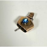 A 9ct gold cow bell style charm mounted blue cabouchon stone in claw setting complete with