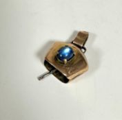 A 9ct gold cow bell style charm mounted blue cabouchon stone in claw setting complete with