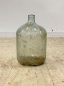 A large green glass demijohn, pontil mark to base, H49cm